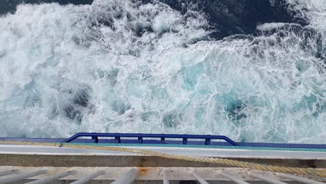 The-view-over-the-side-of-a-passenger-ferry-as-it-sails-through-the-ocean