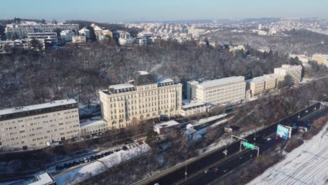 Prague-CSSZ-building-and-traffic-road-in-Smichov,-aerial-drone-sunny-day-side-view,-Czech-Republic