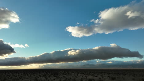 Huge-stratocumulus-clouds-shade-the-Mojave-Desert-at-sunset---aerial-view