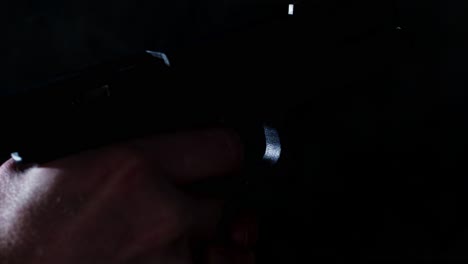 Shell-casing-flying-out-of-fired-Glock-17-handgun-in-slow-motion-in-a-dark-room