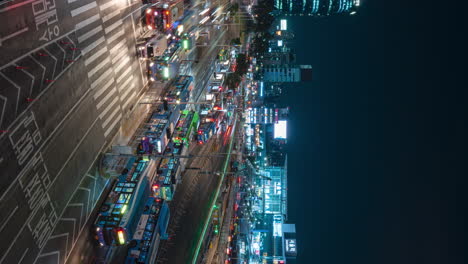 Seoul-Station-Busy-Big-Transport-Interchange-With-Buses-and-Cars-Timelapse-at-Night---elevated-vertical-view