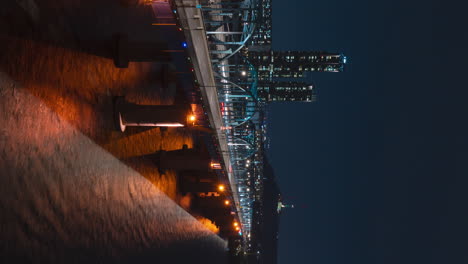 Night-cars-driving-traffic-timelapse-on-Dongjak-Bridge-over-Han-river---vertical-static-aerial-view