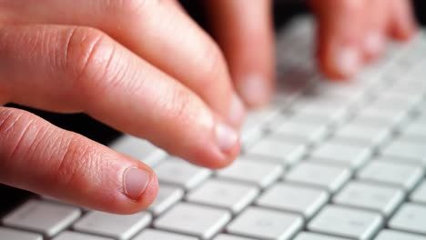 hands-and-fingers-typing-on-keyboard-on-computer---closeup-shot