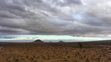 Dramatic-clouds-over-the-Mojave-Desert-after-unseasonable-rain--aerial-flyover