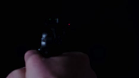 POV-of-pistol-firing-a-single-shot-in-a-dark-room