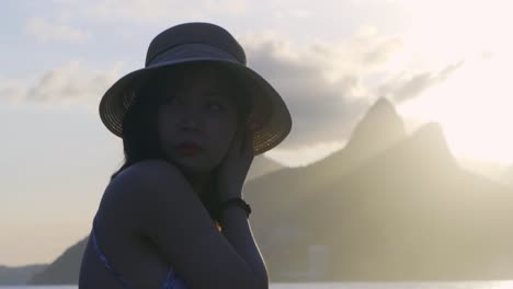 Asian-Woman-watching-the-sunset-on-beautiful-Ipanema-beach-in-Rio-de-Janeiro