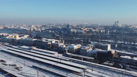 Aerial-drone-view-of-Prague-Smichov-Railway-Station,-winter-city-panorama,-Upper-castle-in-background,-Czech-Republic