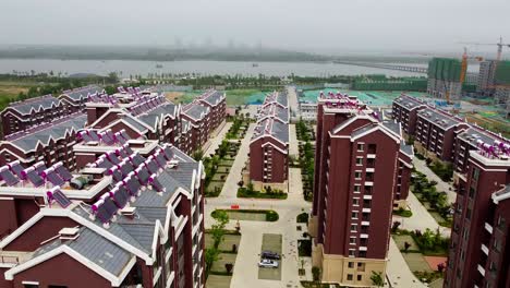 Aerial-tilt-view-of-solar-powered-gingerbread-apartment-buildings-in-Nanhai-New-District,-China