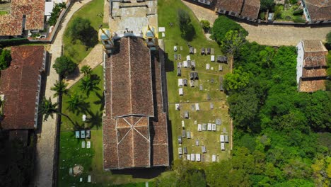 Drone-flying-over-old-baroque-church-and-cemetery-in-the-town-of-Tiradentes,-in-the-interior-of-Brazil