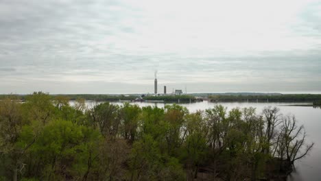 drone-shot-of-coal-power-plant-from-across-a-big-river-and-small-island