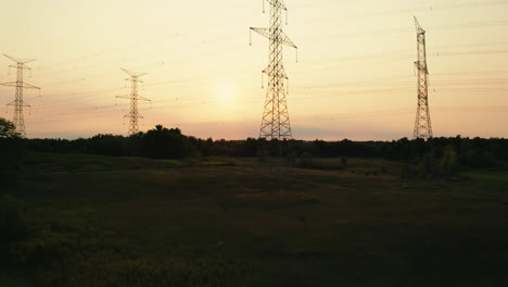 Aerial-Flyover-of-High-Voltage-Transmission-Power-Lines-Silhouette-in-Rural-Countryside
