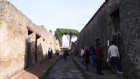 People-exploring-the-ruins-of-Pompeii,-Italy-with-gimbal-video-slowly-walking-forward