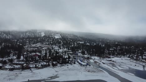 Big-Bear-Lake-California-USA-on-Cold-Winter-Day,-Aerial-Panorama-of-Snowy-Landscape-and-Shoreline