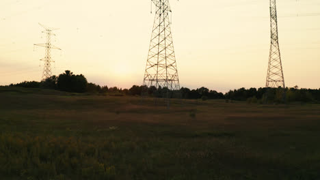 High-Voltage-Electric-Transmission-Power-Lines-Silhouette-in-Rural-Countryside-Field