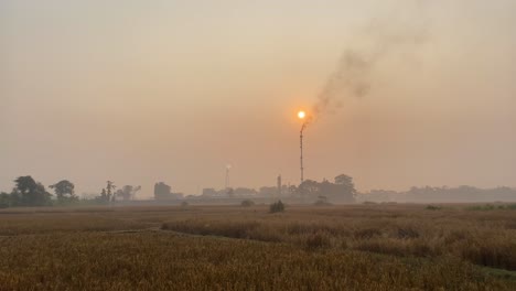 Establisher-view-of-industry-pipe-releasing-fumes-in-air,-Bangladesh,-pan