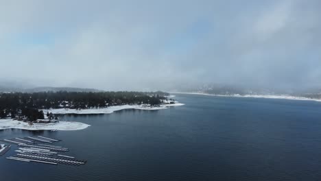 Aerial-View-of-Big-Bear-Lake,-California-USA-on-Cold-Winter-Day,-Alpine-Water-and-Snowy-Landscape-with-rainbow,-Panorama