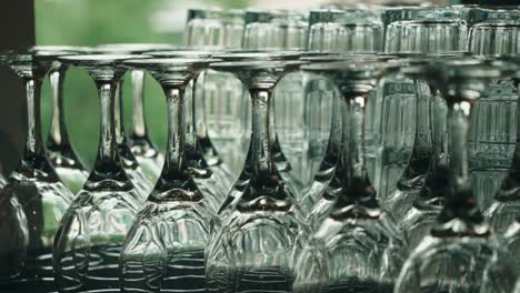 Camera-tilt-up-on-neatly-arranged-wine-and-drink-glasses-for-a-formal-event
