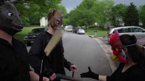 Masked-Goons-with-Gun-and-other-Weapons-walking-through-Suburban-Neighborhood---Slow-Motion