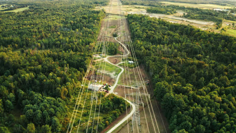 Aerial-Flyover-of-High-Voltage-Transmission-Power-Lines-Passing-through-Dense-Forest-in-Rural-Countryside