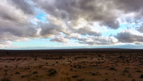 Puddles-in-the-Mojave-Desert-after-a-rare-thundershower---aerial-flyover