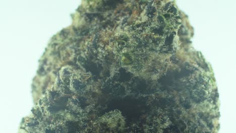 Macro-Close-up-shot-of-a-Marijuana-sativa-Super-Lemon-Amnesia-Haze-rock-flower,-yellow,-green-and-purple-Kush,-on-a-360-rotating-stand,-Slow-motion-4K-video