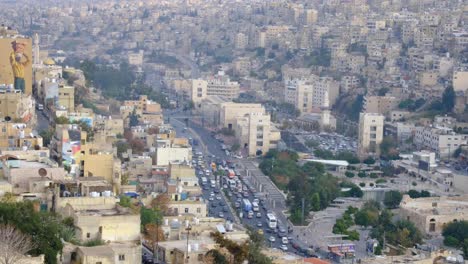 Busy-traffic-on-the-streets-and-densely-packed-houses,-buildings-and-high-rises-of-capital-city-Amman-in-Jordan