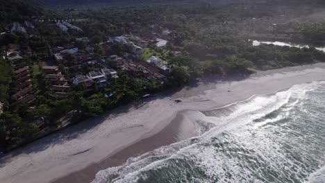Drone-goes-up-and-backwards-revealing-a-shore-and-the-atlantic-rainforest-landscape