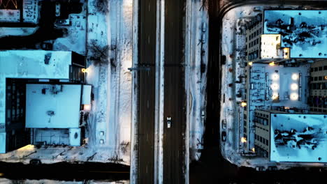Cinematic-aerial-view-of-Minneapolis-city-freeway-after-snow-storm