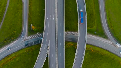 An-aerial-view-a-country-highway-with-a-bridge-and-overpasses-on-which-cars-and-trucks-travel