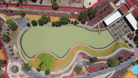 Drone-headshot-f-a-Construction-park-with-turquoise-pool-in-the-center-in-Mexico
