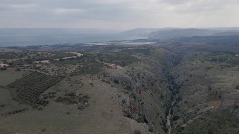 Flyover-aerial-view-of-Israel-landscape-and-valley-with-mountains-in-background
