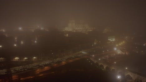 Melancholic-night-with-mist-in-the-sky,-aerial-drone-view-over-the-city-of-Salamanca,-Spain