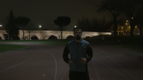 Athletic-Person-Warming-Up-On-Terrain-Before-Start-Jogging,-Aqueducts-In-Background
