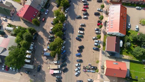 Busy-streets-of-Sveksna-town-with-local-market-on-sunny-day,-aerial-top-down-view