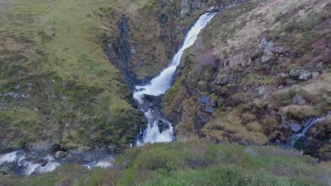 Tilting-shot-of-a-waterfall-at-the-Gray-Mares-Trail-falling-after-heavy-rainfall
