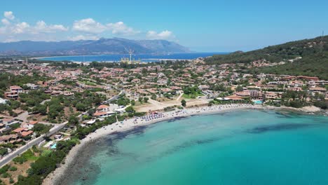 Arbatax-Beach-and-Port-in-the-background-in-Sardinia,-Italy---Aerial-4k
