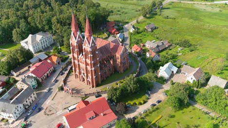 Sveksna-Township-and-iconic-red-brick-church-with-two-towers,-aerial-view