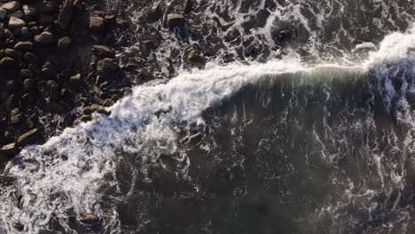 Waves-breaking-at-the-golden-hour-Drone-top-view-in-slowmotion