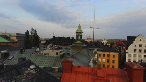 Drone-rising-over-the-roofs-in-Gamla-Stan,-Stockholm,-Sweden