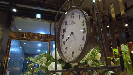 Parallax-around-fancy-clock-in-lobby-of-modern-building,-Suncheon,-South-Korea
