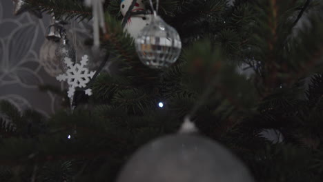 Silver-ornaments-on-the-Christmas-tree,-close-up-top-down