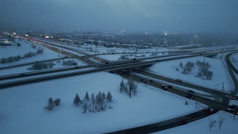 Drone-shots-during-a-frosty-winter-evening-as-cars-pass-along-a-bridge-on-a-freeway