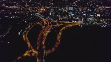 Aerial-drone-of-Perth-City-Western-Australia-at-night,showing-the-dynamic-nature-of-the-city-by-means-of-the-freeway-entering-the-city