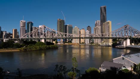 Ferry-travelling-under-the-Story-Bridge-to-Brisbane-City-from-Wilson-Outlook-Reserve,-New-Farm