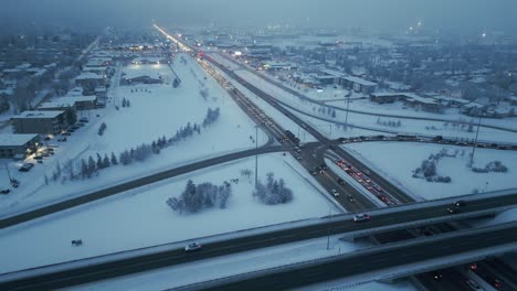 Drone-shot-of-freeway-or-highway-traffic-during-rush-hour-on-a-foggy,-winter-evening