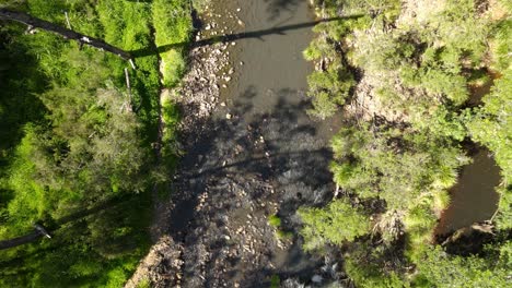 Revealing-drone-view-of-a-scenic-bush-creek-flowing-through-an-Australian-outback-countryside