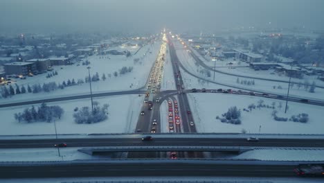 Drone-shot-straight-down-freeway-or-highway-traffic-during-rush-hour-on-a-foggy-and-winter-evening