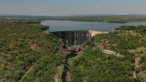 Drone-dolly-zoom---Flying-over-a-dam-wall-birds-eye-view-down