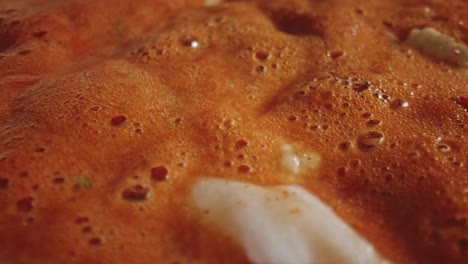 Extreme-Close-Up-Of-Simmering-Bubbles-In-Hot-Tomato-Stew-Soup-With-Chicken-Pieces
