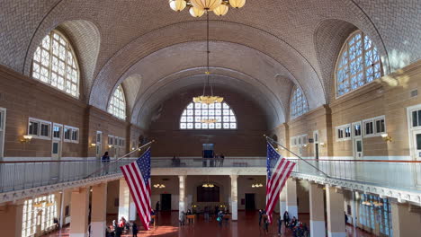 several-tourists-visit-the-hall-of-the-former-border-post-on-Ellis-Island